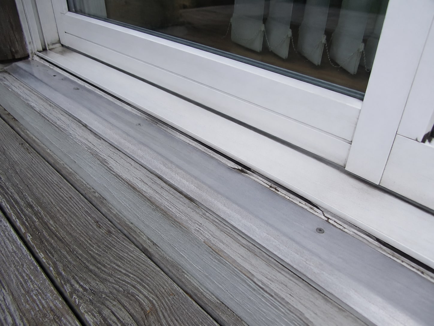 Patio slider threshold and separated sealant joint.