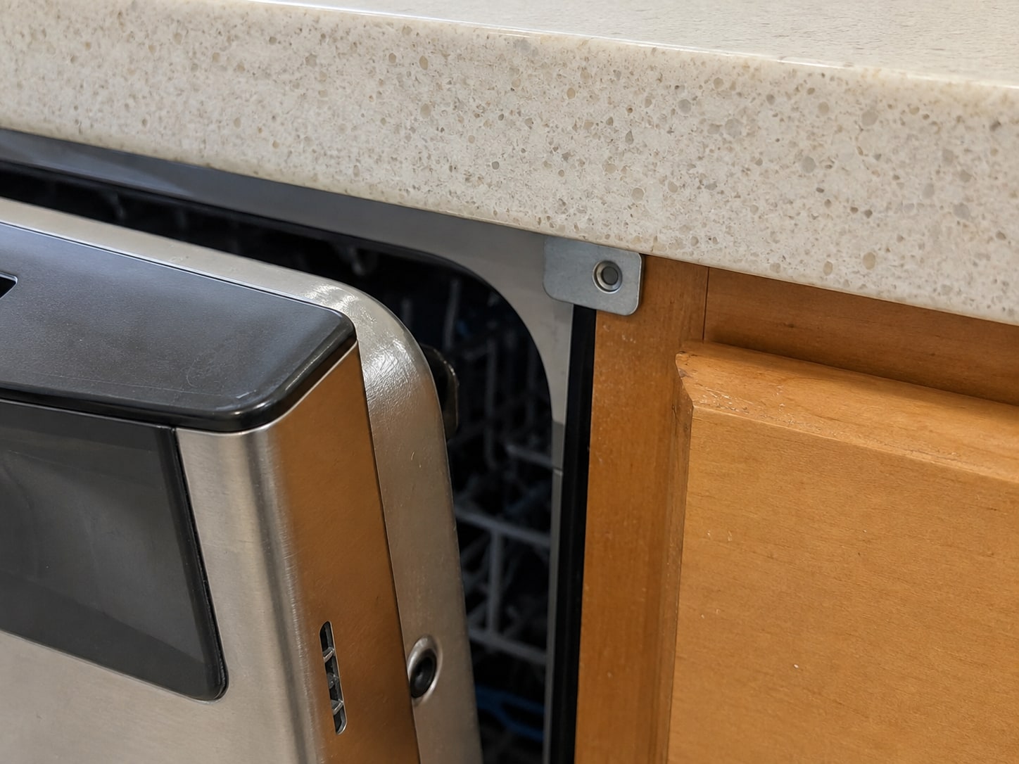 Upper dishwasher attachment below the countertop.