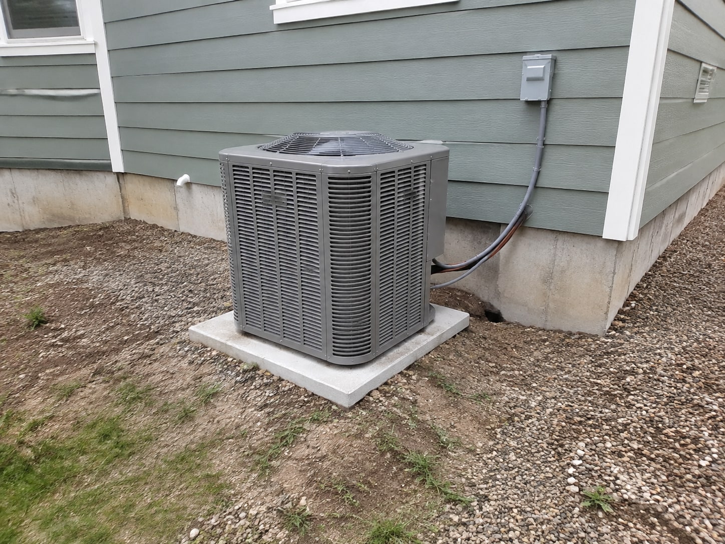 System A outdoor unit, service pad and adjacent enclosure.